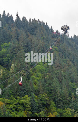 Mt/ Mount Roberts Tramway, a famous aerial tourist attraction in Juneau Alaska with trams ascending and descending from mountains. Stock Photo