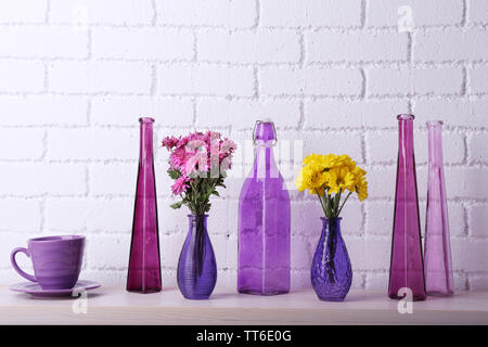 Fireplace with beautiful purple decorations in room Stock Photo