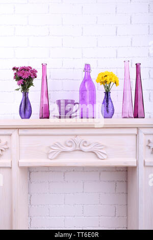 Fireplace with beautiful purple decorations in room Stock Photo