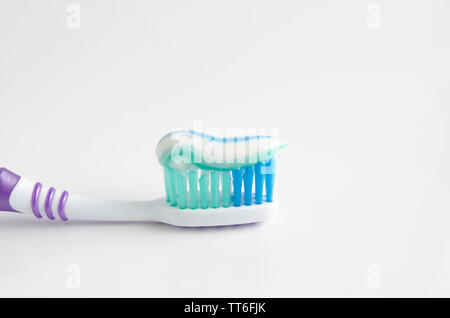 Toothpaste squeezed on the toothbrush on white background Stock Photo