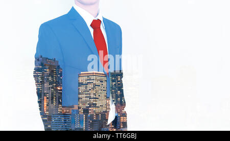 Business concept. Businessman in blue suit and red necktie, with double exposure panoramic business office buildings in the city, on white background Stock Photo