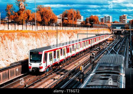 SANTIAGO, CHILE - OCTOBER 2015: Two trains of the Santiago Metro with the clouds as a background Stock Photo