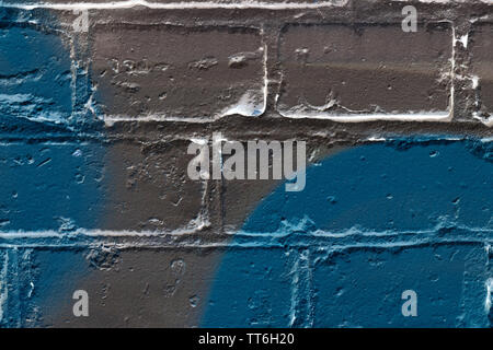 Brick wall painted in different colors close up. Abstract background Stock Photo