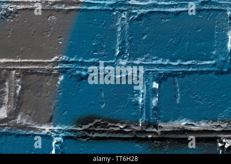 Brick wall painted in different colors close up. Abstract background Stock Photo