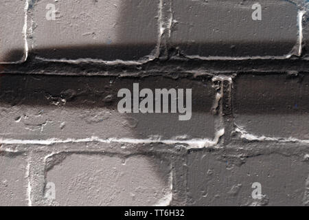 Brick wall painted in different colors close up. Abstract background Stock Photo