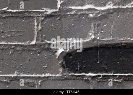 Brick wall painted in different colors close up. Abstract background Stock Photo