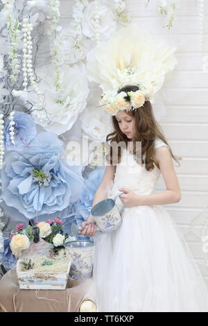 small smiling girl in a wreath is hidden a bunch of flowers Stock Photo ...