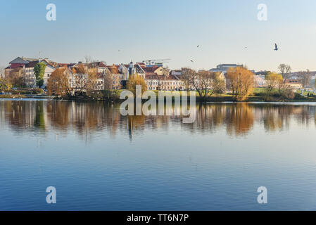 View of Traetskae Pradmestse or Trinity Suburb and Island of Tears Chapel or Island of Courage and Sorrow on Svisloch river bank in historical center Stock Photo