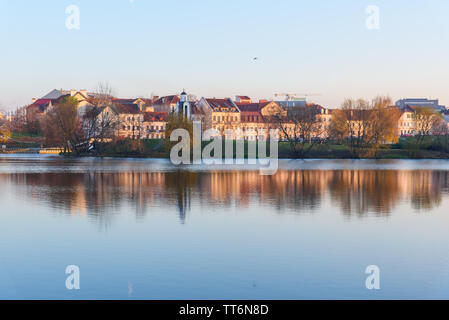 View of Traetskae Pradmestse or Trinity Suburb and Island of Tears Chapel or Island of Courage and Sorrow on Svisloch river bank in historical center Stock Photo