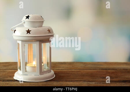 https://l450v.alamy.com/450v/tt6phj/lantern-on-wooden-surface-and-blurred-background-tt6phj.jpg