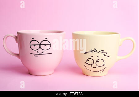Emotional cups on pink background Stock Photo - Alamy