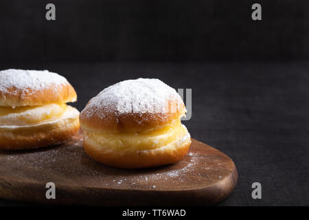 Homemade berlin donuts on a table top close up on a dark background Stock Photo