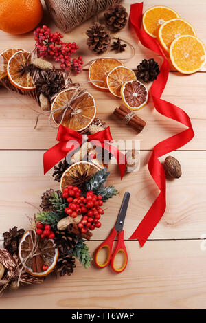 Christmas wreath with materials for decorating on wooden background Stock Photo