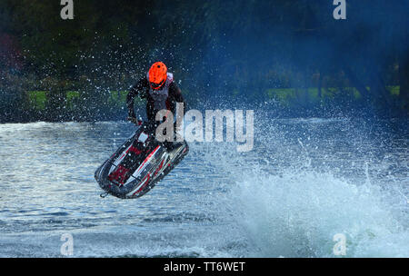 Freestyle Jet Skier performing 360  creating at lot of spray Stock Photo