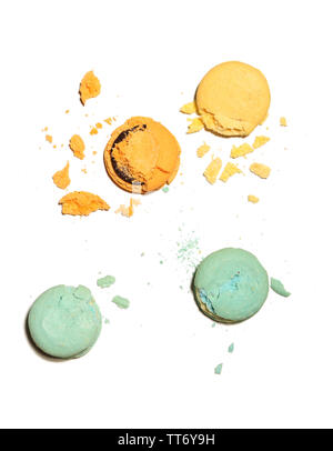 Bright tasty broken macaroons cakes, isolated on white Stock Photo