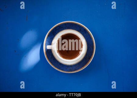 Cup of Turkish coffee on Greek blue table