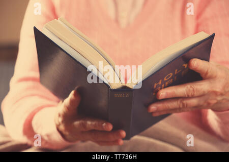 Old woman reading Bible, closeup Stock Photo