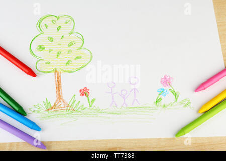 Kids drawing of family and colored pencils on wooden table Stock Photo -  Alamy