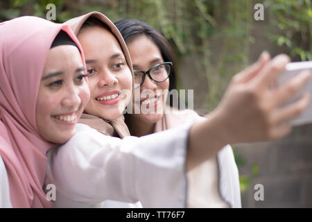 happy best friend  woman muslim taking selfie together Stock Photo