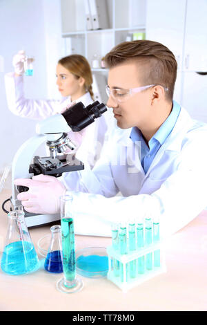 Young male chemist student working in the lab Stock Photo - Alamy