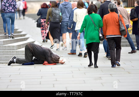People passing a homeless man begging for money, London Stock Photo - Alamy