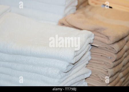 Clean White Towels and Brown Towels on shelf Stock Photo