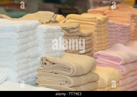 Clean White Towels and Brown Towels on shelf Stock Photo