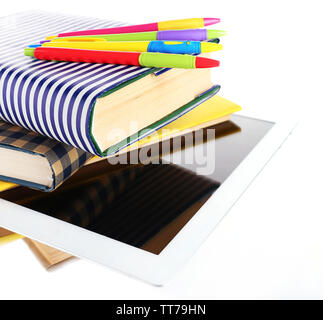 Pile of books with tablet isolated on white Stock Photo