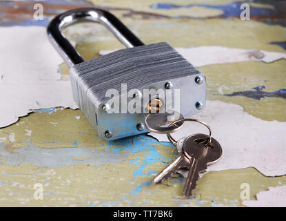 Padlock with keys on wooden background Stock Photo