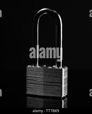 Steel padlock on the black textured background Stock Photo - Alamy