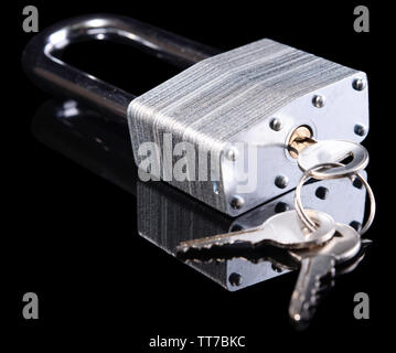 Padlock with keys isolated on black Stock Photo