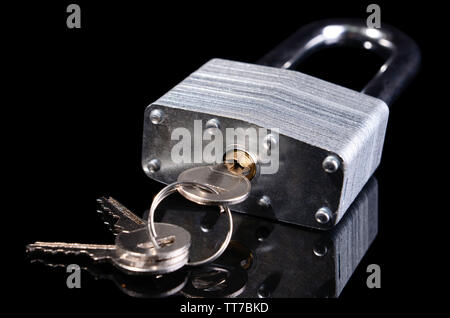 Padlock with keys isolated on black Stock Photo