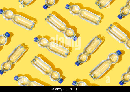 Mineral water bottles pattern on yellow background Stock Photo