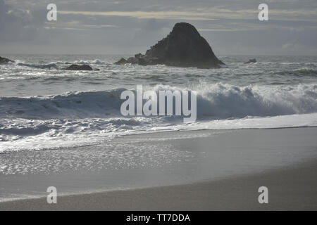 Waves rolling onto a sandy beach. Stock Photo