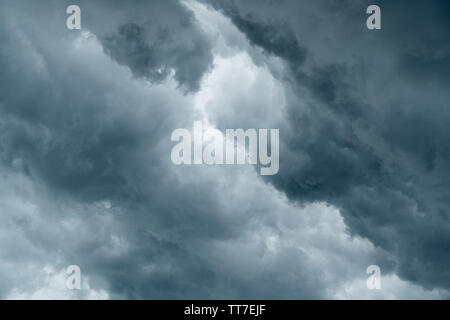 storm cloud background during raining. Dark Clouds. Huge black clouds on dark sky before a thunder-storm. Stock Photo
