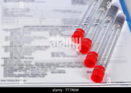 Test tubes and clipboard with medical history form close up Stock Photo