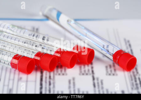 Test tubes and clipboard with medical history form close up Stock Photo