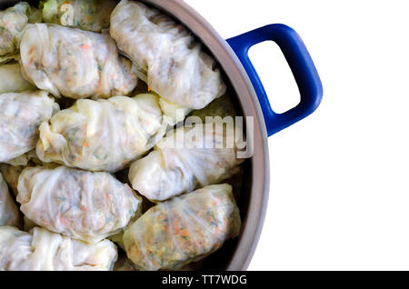 Cabbage Rolls or Dolma. Stuffed cabbage leaves with minced meat, rice, vegetables and herbs in casserole. Isolated on white backround with copy space Stock Photo