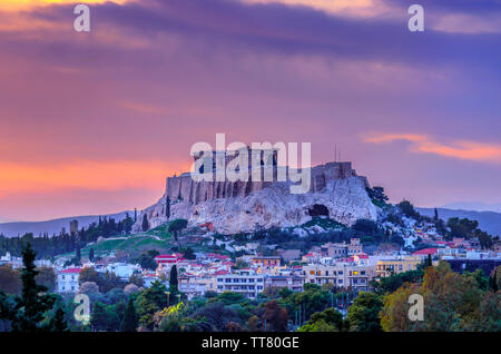 The Acropolis of Athens city in Greece with the Parthenon Temple (dedicated to goddess Athena) as seen from the Panathenaic Stadium, at sunset time Stock Photo