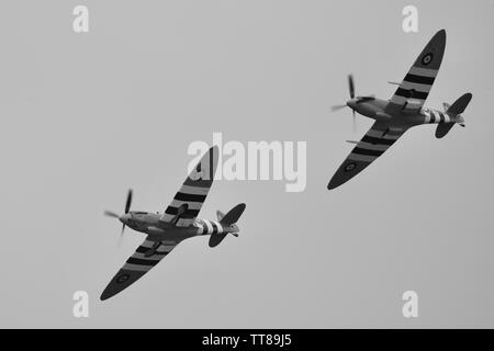 Daks over Normandy - 2 Supermarine Spitfires flying in formation to commemorate the 75th anniversary of D-Day at the IWM Duxford on the 4th June 2019 Stock Photo