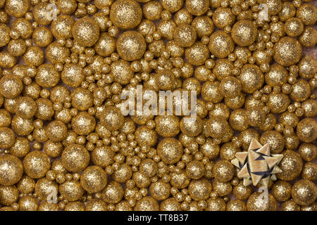 Christmas background with big and small golden glitter balls and golden ribbon star Stock Photo