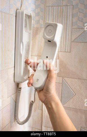 hand pressing a button on the intercom at home, closeup Stock Photo