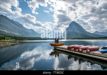 September 1, 2018, Canoes on Swift Current Lake, Reflections, Glacier National Park, Montana Stock Photo
