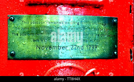 June 15, 2019, marks the 23rd anniversary of the IRA bomb which devastated the city centre of Manchester uk in 1996. This postbox on Corporation Street remained standing and bears a memorial plaque to mark this. The brass plaque carries the inscription: 'This postbox remained standing almost undamaged on June 15, 1996 when this area was devastated by a bomb. The box was removed during the rebuilding of the city centre and was returned to its original site on November 22nd 1999'. The bomb injured some 200 people. No-one has yet been charged with planting the bomb. Stock Photo