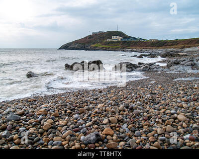 A view from Bracelet Bay towards the old coastguard station with views across the sea to the coast of north Devon. Swansea, Gower, Wales, UK. Stock Photo