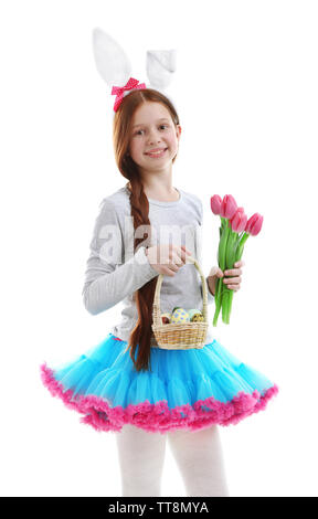 Beautiful little girl wearing Easter bunny ears and holding wicker basket with Easter eggs, isolated on white Stock Photo