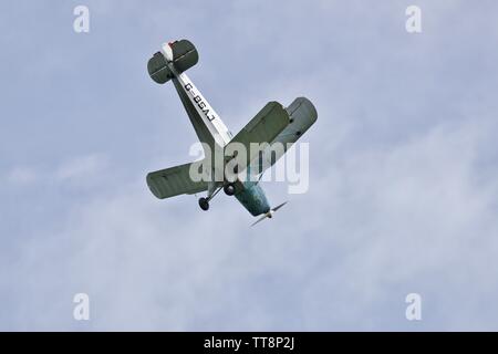 Bücher Jungmann G-BSAJ with the 1936 Berlin Olympics colour scheme flying at the Shuttleworth Flying Festival Airshow on the 2rd June 2019 Stock Photo