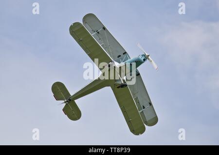 Bücher Jungmann G-BSAJ with the 1936 Berlin Olympics colour scheme flying at the Shuttleworth Flying Festival Airshow on the 2rd June 2019 Stock Photo