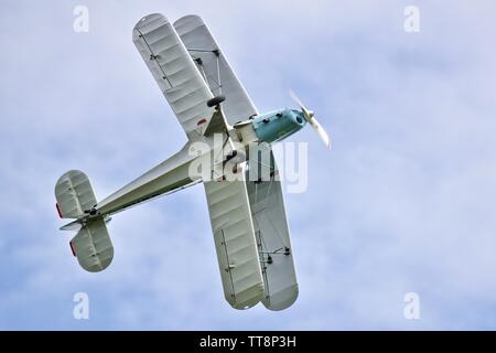 Bücher Jungmann G-BSAJ with the 1936 Berlin Olympics colour scheme flying at the Shuttleworth Flying Festival Airshow on the 2rd June 2019 Stock Photo