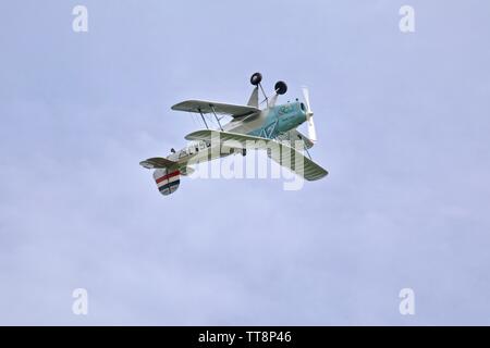 Bücher Jungmann G-BSAJ with the 1936 Berlin Olympics colour scheme flying at the Shuttleworth Flying Festival Airshow on the 2rd June 2019 Stock Photo